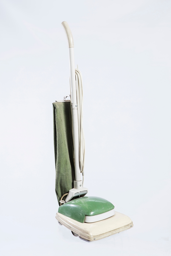 Vintage brown vacuum cleaner isolated on a white background