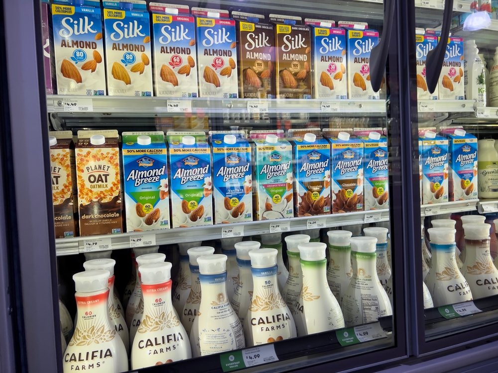 Mill Creek, WA USA - circa April 2022: Angled, selective focus on dairy products inside the refrigerated section of a Town and Country grocery store.

