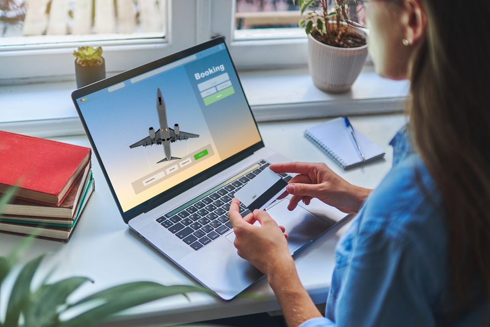 Online booking and buying plane tickets using computer and credit card
