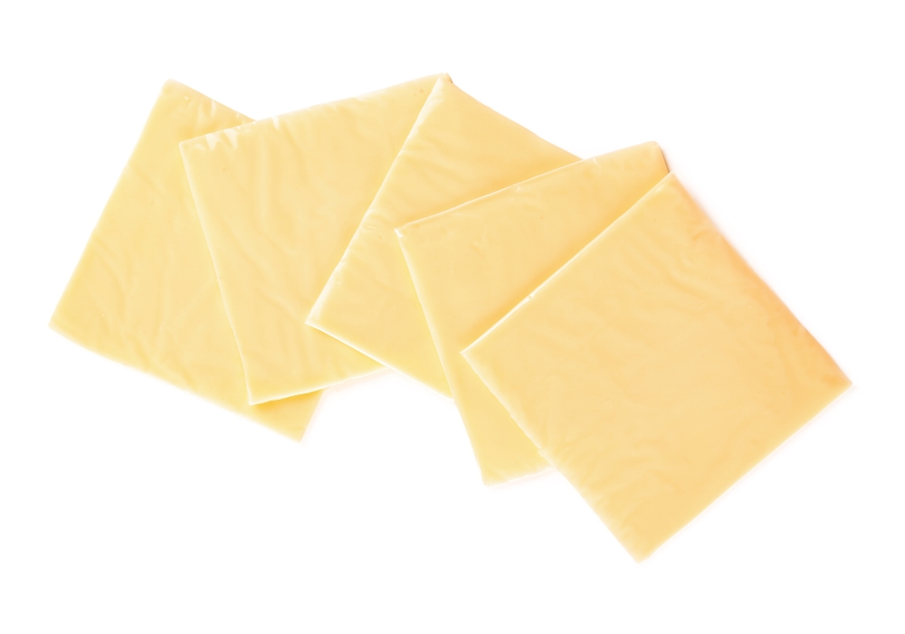 Slices of tasty processed cheese on white background