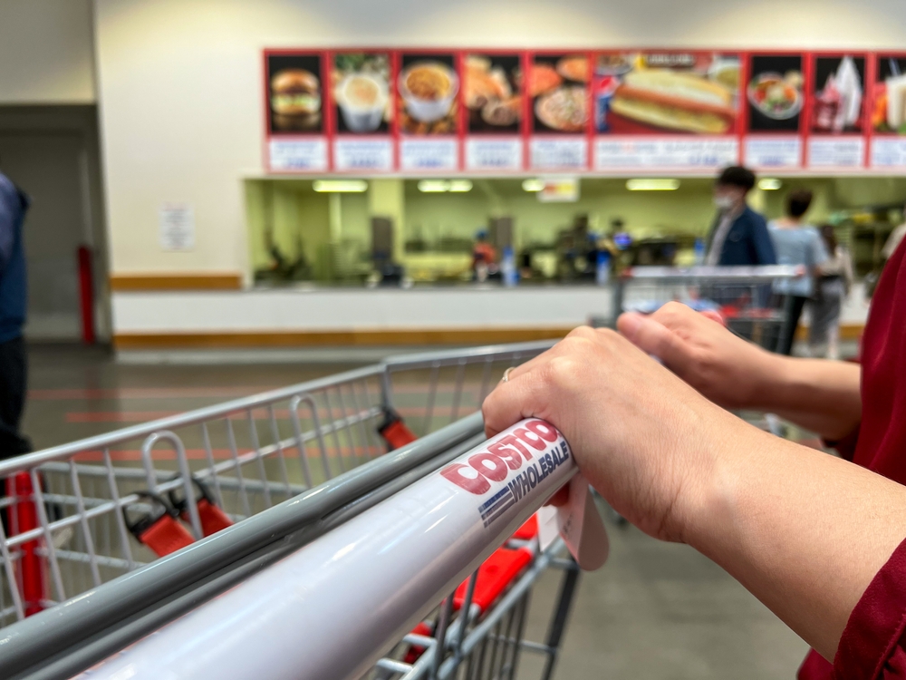 Kitakyushu, Fukuoka, Japan - May 26, 2023: Hands pushing a Costco cart while shopping at Costco

