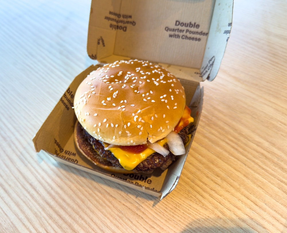 Los Angeles, CA - August 1, 2023: Closeup of Double Quarter Pounder with Cheese in a cardboard box from McDonalds fast food restaurant.