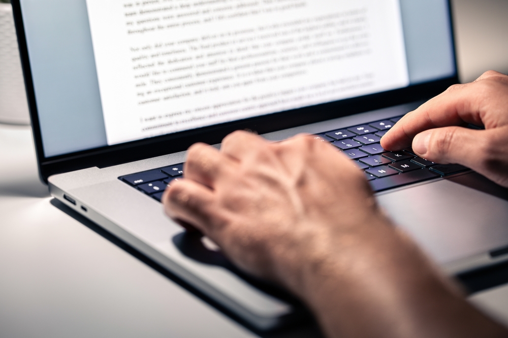 person using laptop to write review