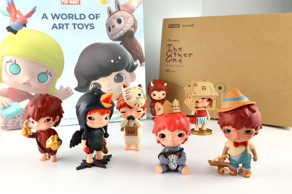 art toys Hirono version 1 collection from Pop Mart blind box collectable cute toys display on white shelf background at Pop mart flagship store during new release promotion event Hirono the other one
