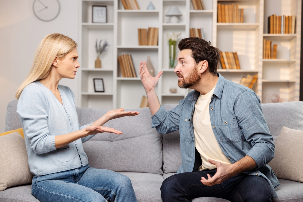 couple fighting on couch