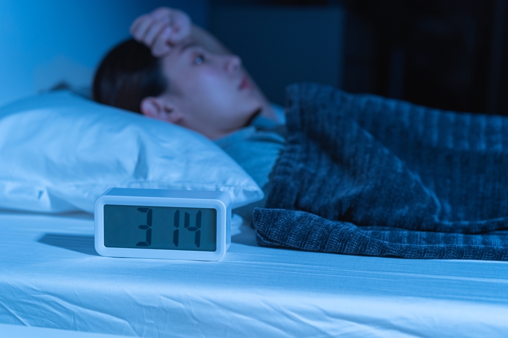 Annoyed, stressed, anxiety asian young woman suffering from insomnia, frustrated awake on bed at night, headache or migraine, health care problem, disturbed trouble of loud noise, unable sleepless.