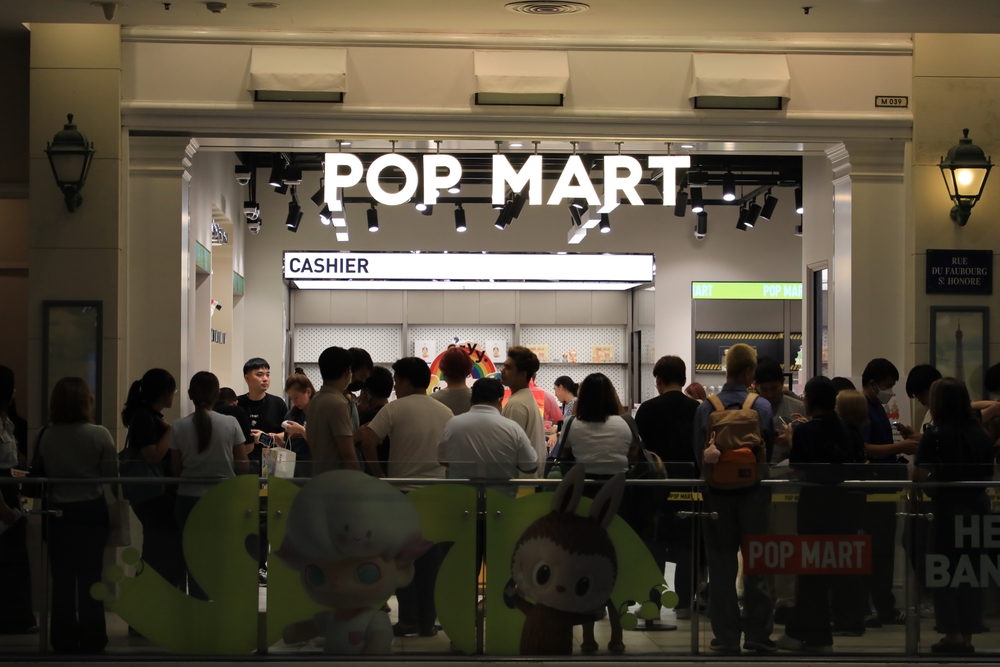 Bangkok, Thailand, May 4, 2024: People stand and wait in a queuing line to buy a new collection of designer toys in front of a pop-mart area in Terminal 21 Asok Shopping Mall.