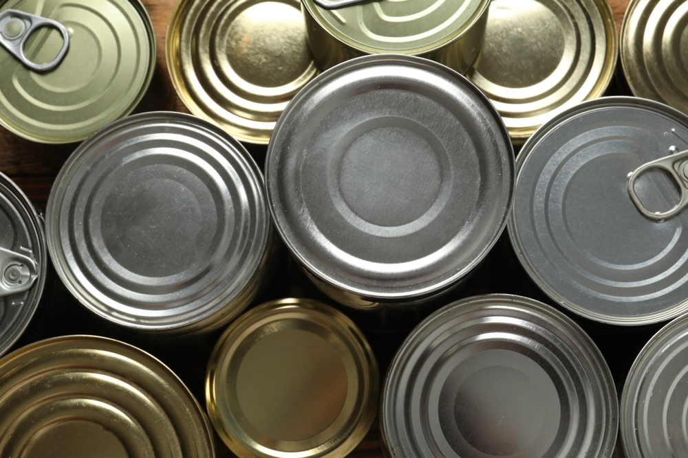 Hard cans of food on a wooden background
