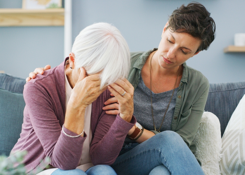 Elderly mom, stress and daughter with support for mental health crisis, compassion and dementia in home. Senior mother, sad and woman with empathy for retirement debt, kindness and financial mistake