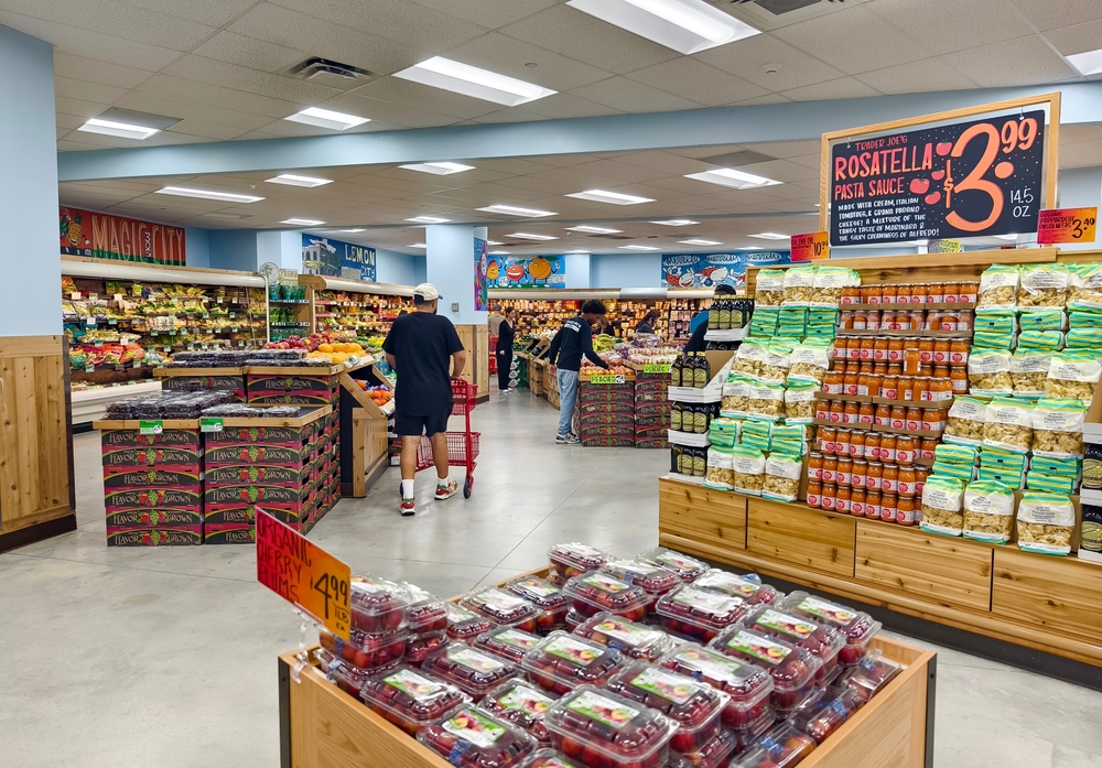 Miami, Florida - July 9, 2024: Customers shop for groceries at Trader Joe's. The store features fresh produce, packaged foods, and other grocery items.
