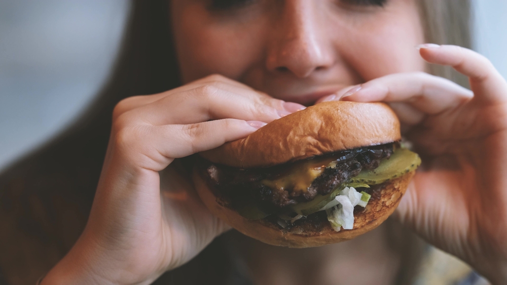 Los Angeles, CA - August 1, 2023: Closeup of Double Quarter Pounder with Cheese in a cardboard box from McDonalds fast food restaurant.