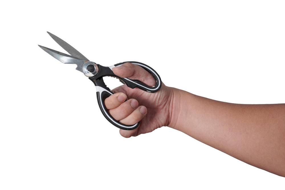 Male person hand holding scissor, cut out isolated on white