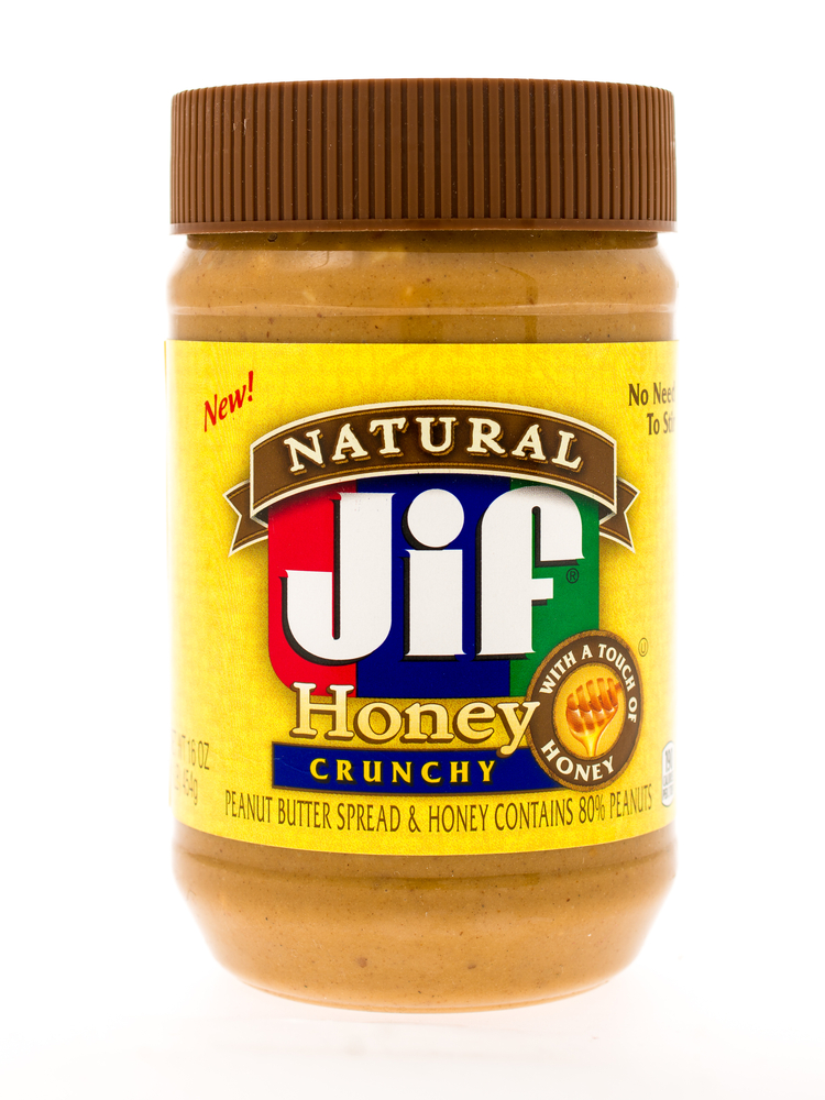 Winneconne, WI - 3 May 2015:  Jar of Jif natural peanut butter with honey in crunchy style.