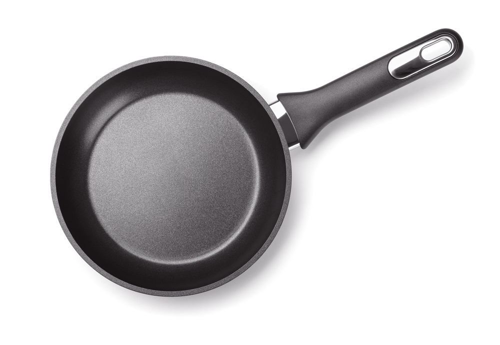 Top view of new empty frying pan isolated on white
