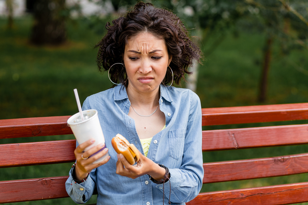 woman looking disgusted at food