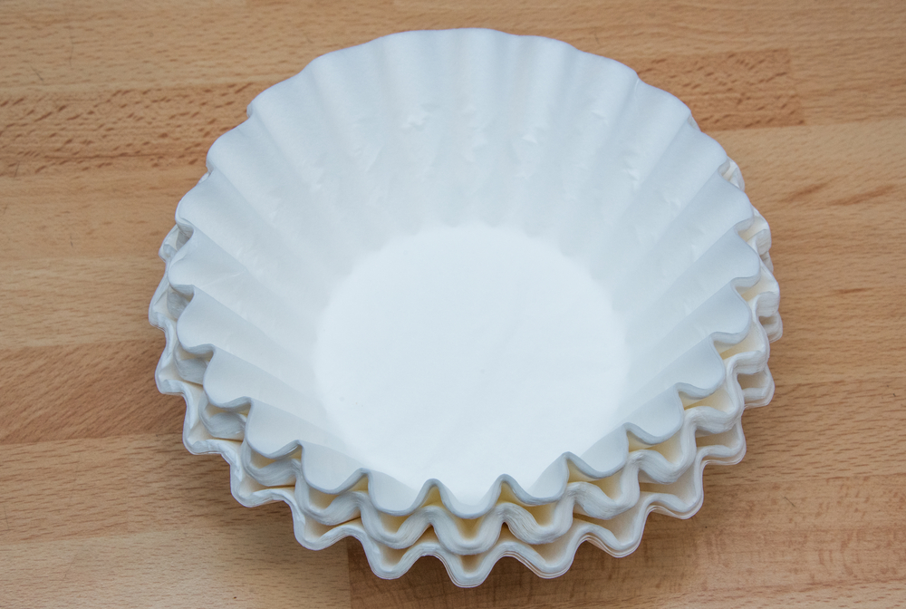 Coffee filters made from paper isolated on a wooden background