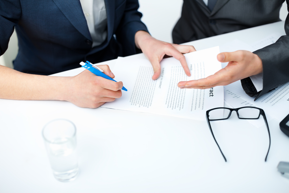 Close up of businessman's hands signing a contract
