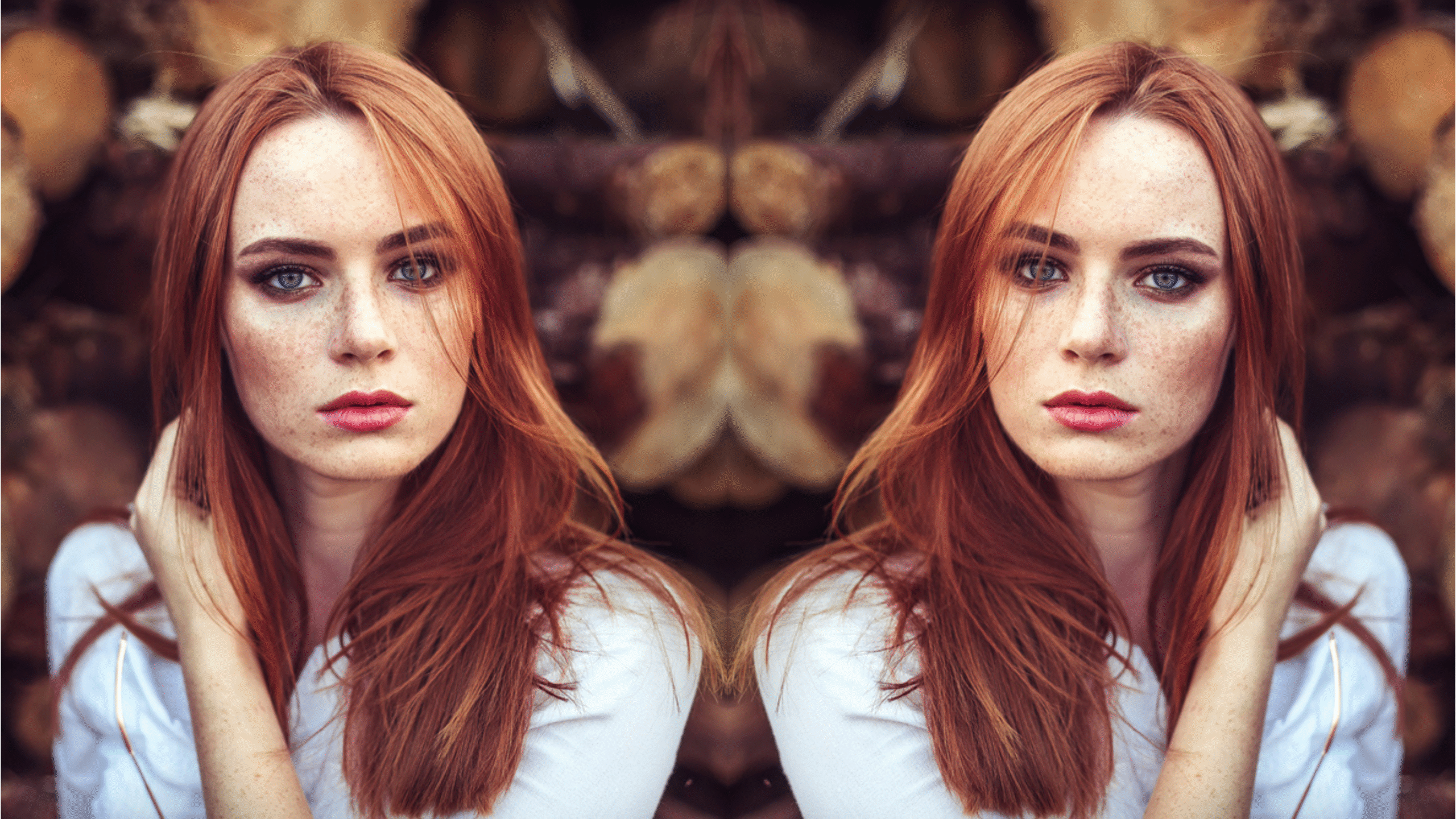 Portrait of young tender redhead young girl with healthy freckled skin wearing white top looking at camera with serious or pensive expression. Caucasian woman model with ginger hair posing outdoors