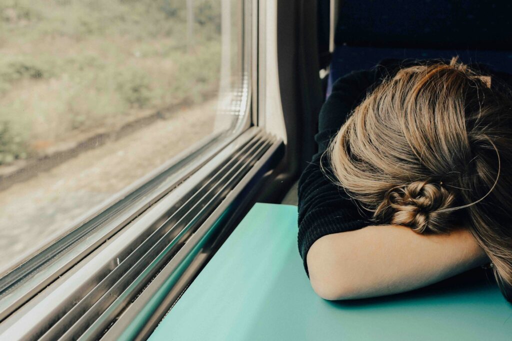 sleeping woman in train at daytime
