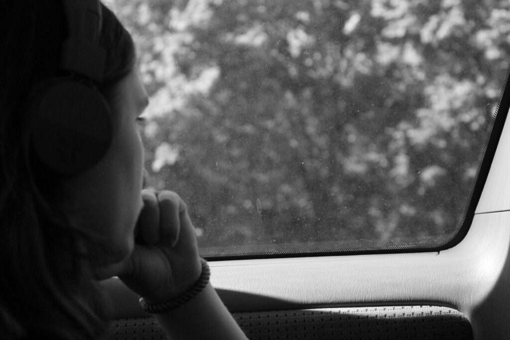grayscale photo of woman inside car
