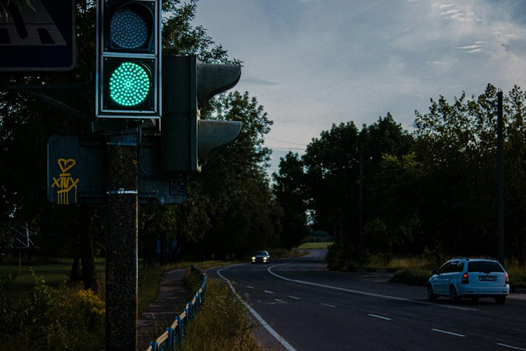 A green traffic light sitting on the side of a road
