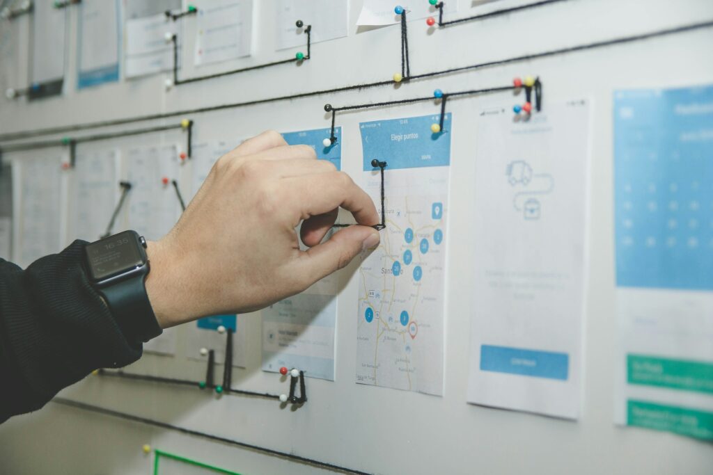 person working on blue and white paper on board
