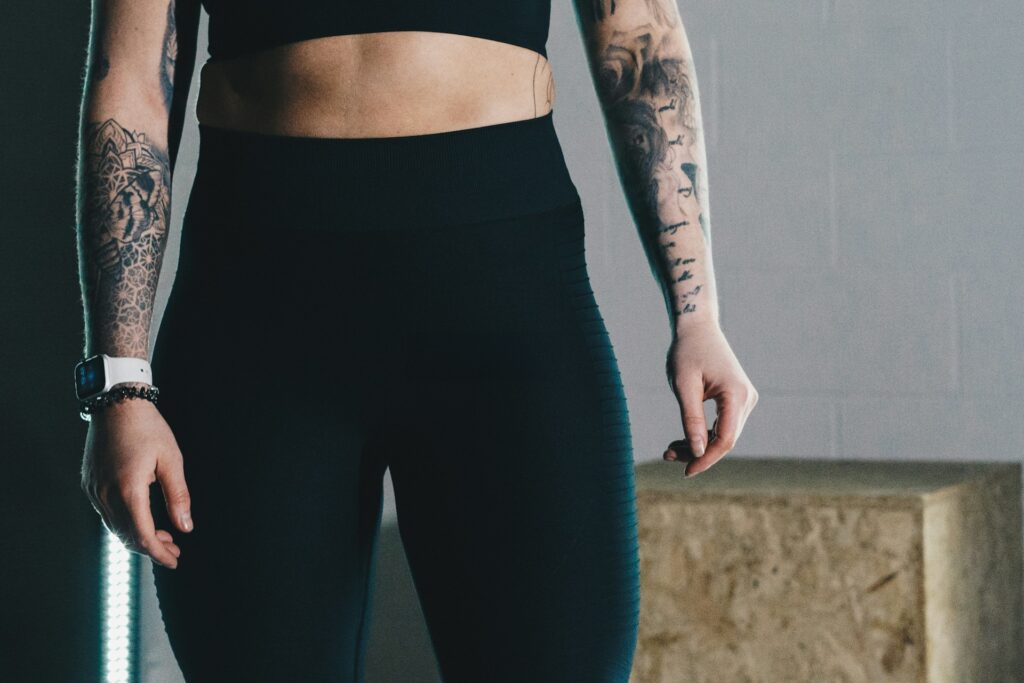a woman in a black sports bra top and leggings

