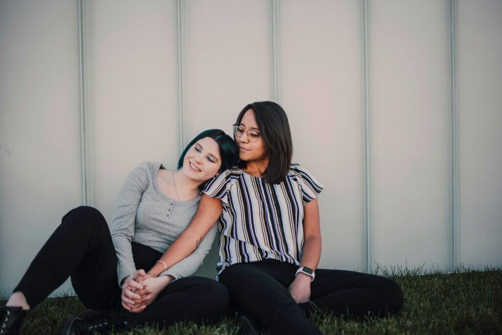2 women sitting on couch
