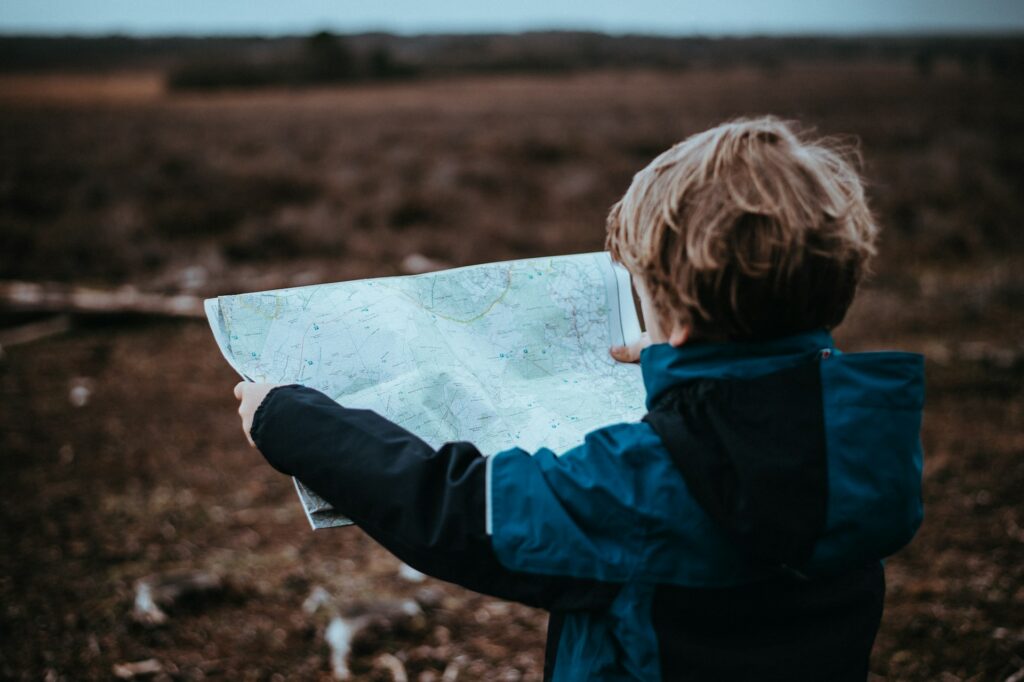 child looking at map
