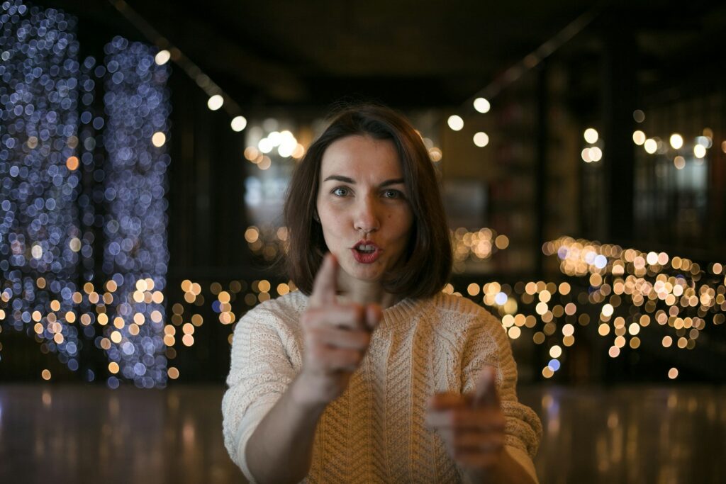 a woman making a funny face with her finger
