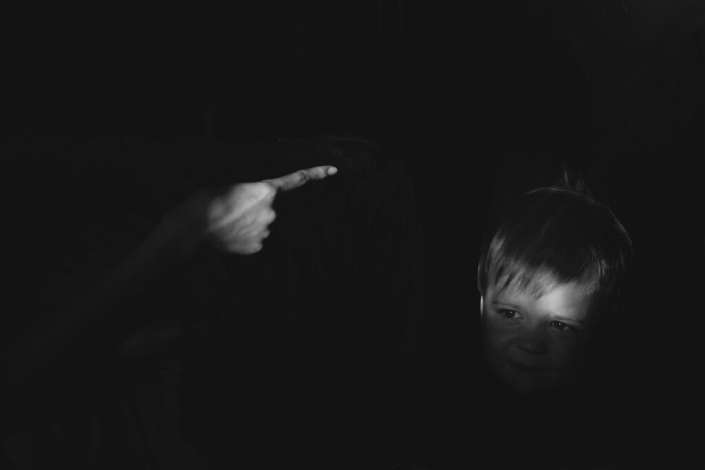 grayscale photo of girl holding her chin

