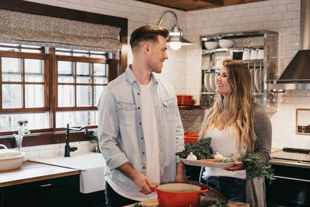 man and woman standing inside kitchen room
