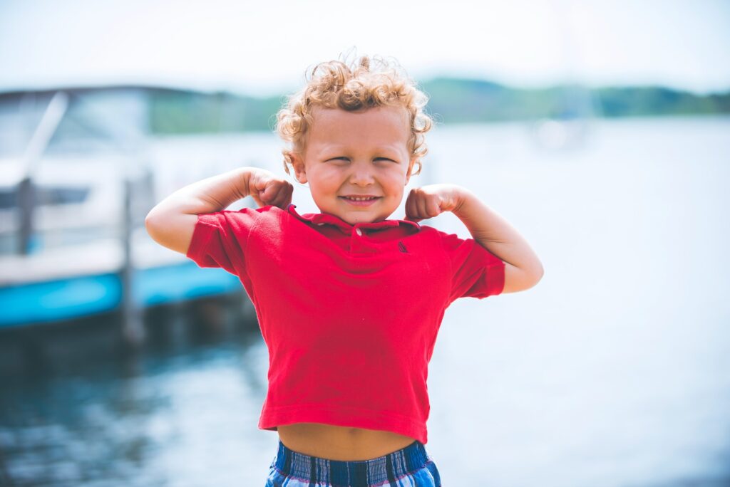 boy standing near dock
