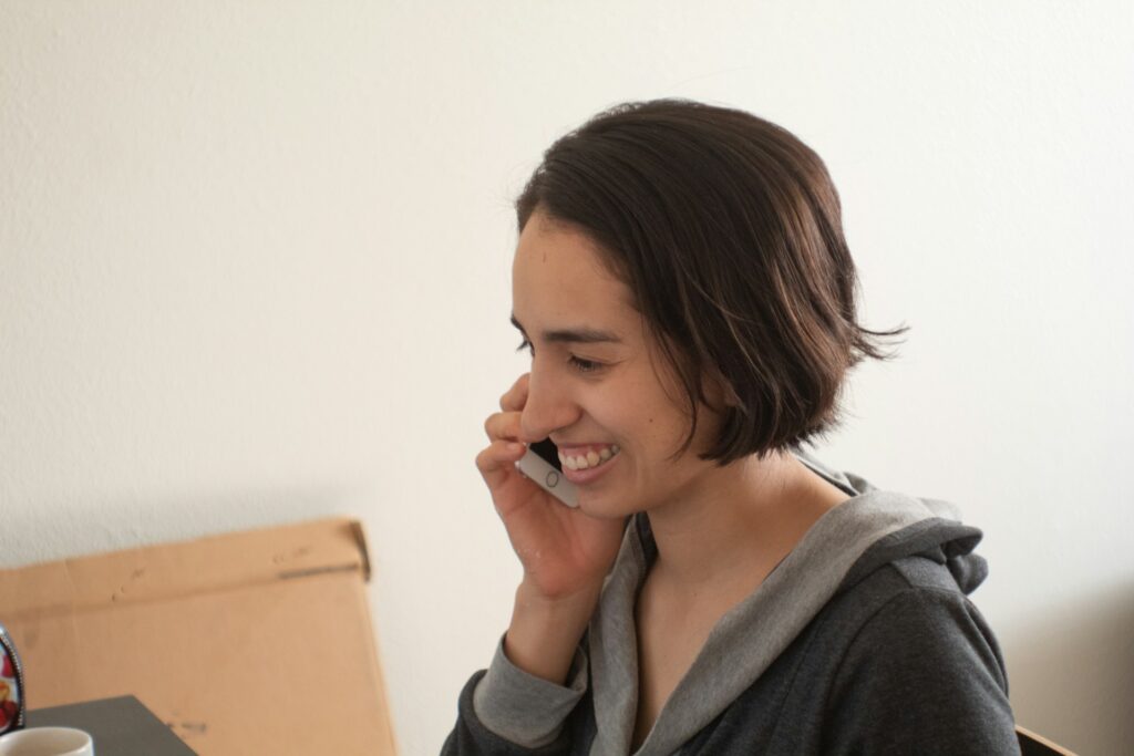 woman in gray hoodie smiling
