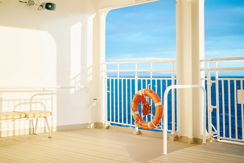 An orange life preserver sitting on top of a wooden floor
