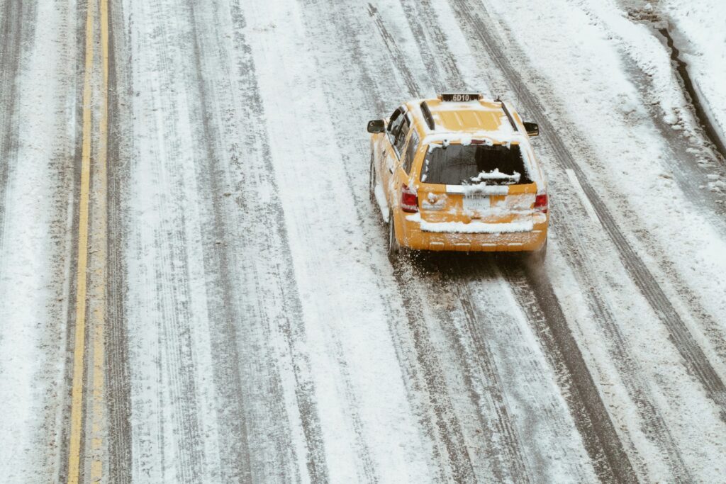 aerial shot of yellow car on the road
