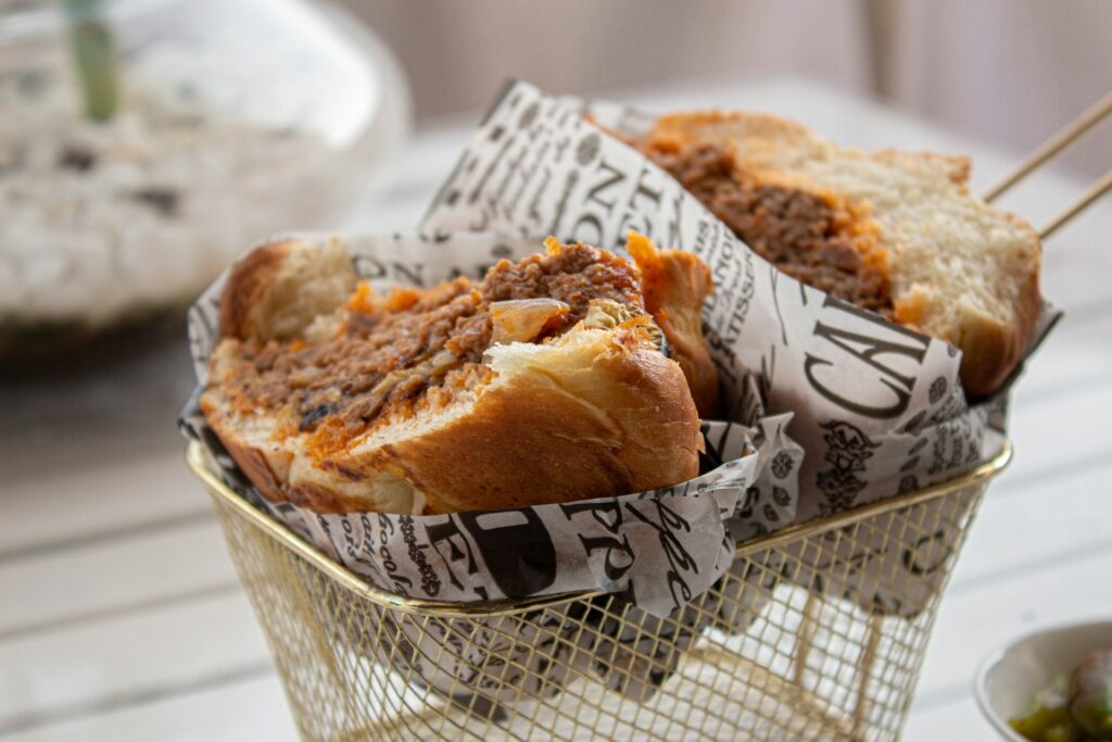 a close up of a sandwich in a basket on a table
