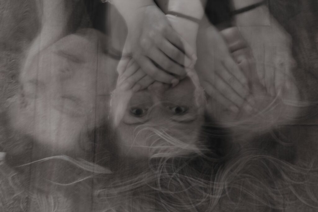 grayscale forced perspective photography of woman's face
