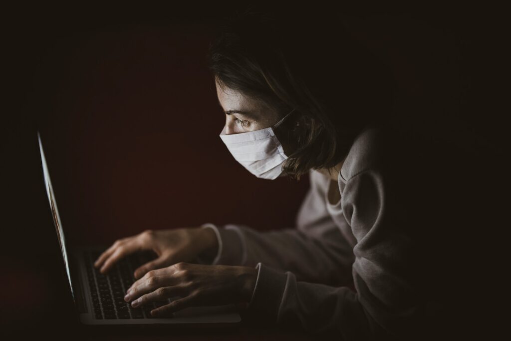 woman in long sleeve shirt using laptop computer
