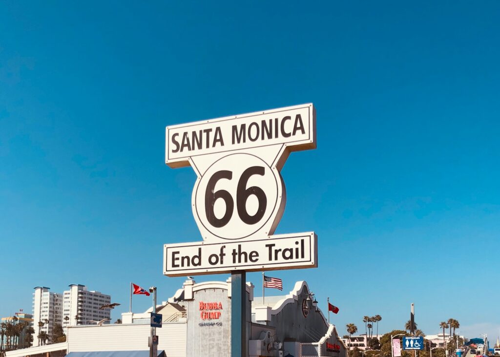 a street sign for santa monica and the end of the trail
