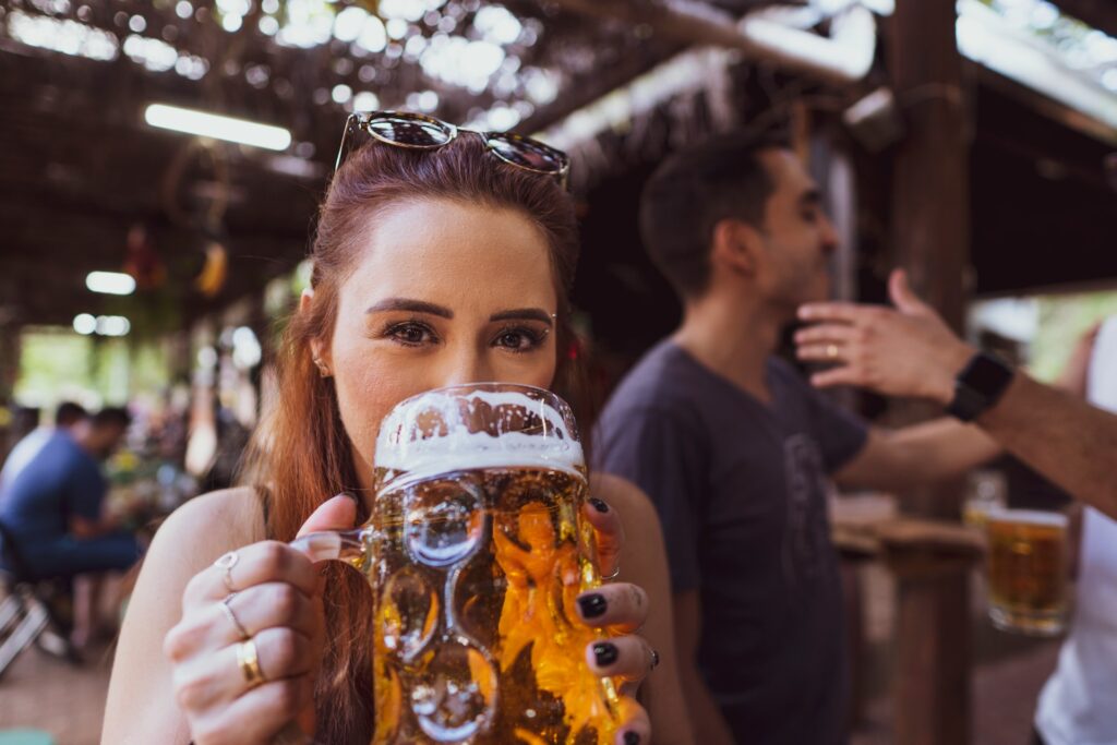 woman in black sleeveless shirt holding drinking glass
