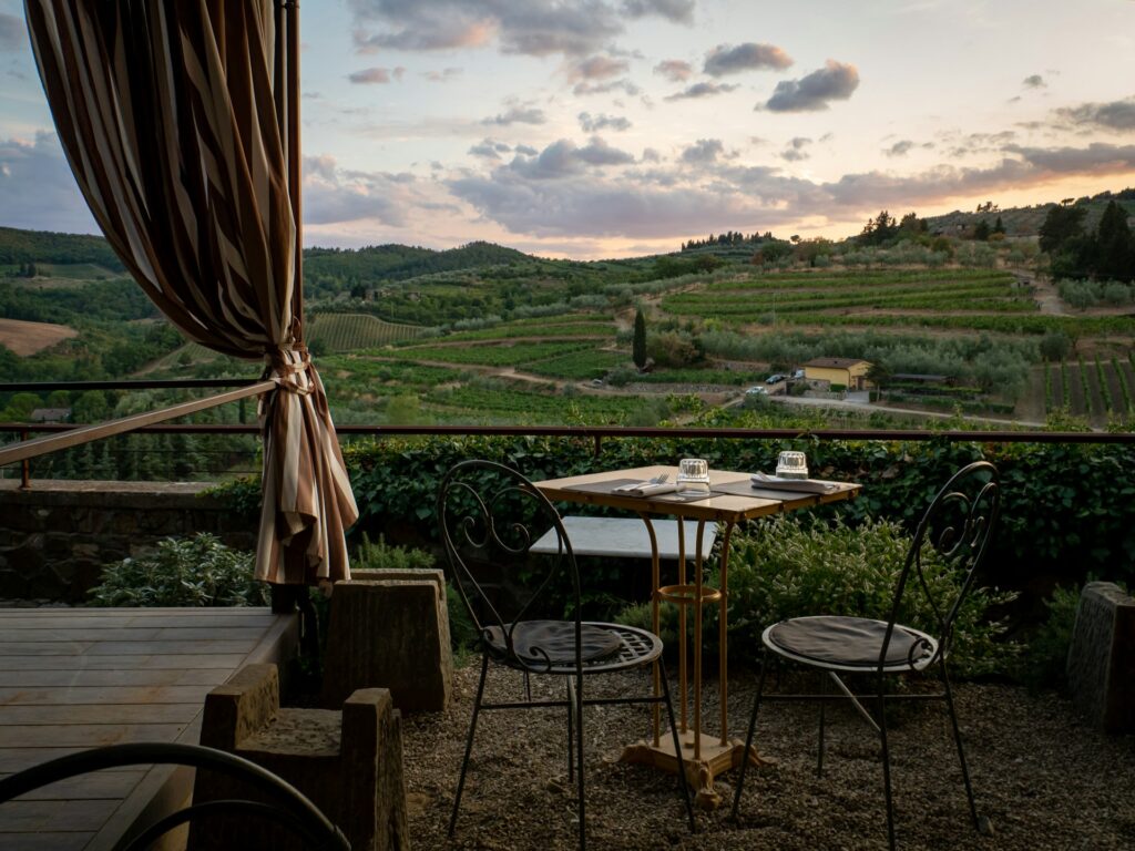 a table and chairs on a patio with a view
