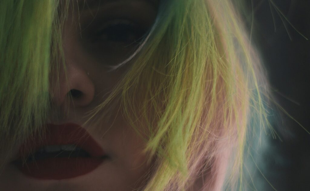 woman with blonde hair and black eye shadow
