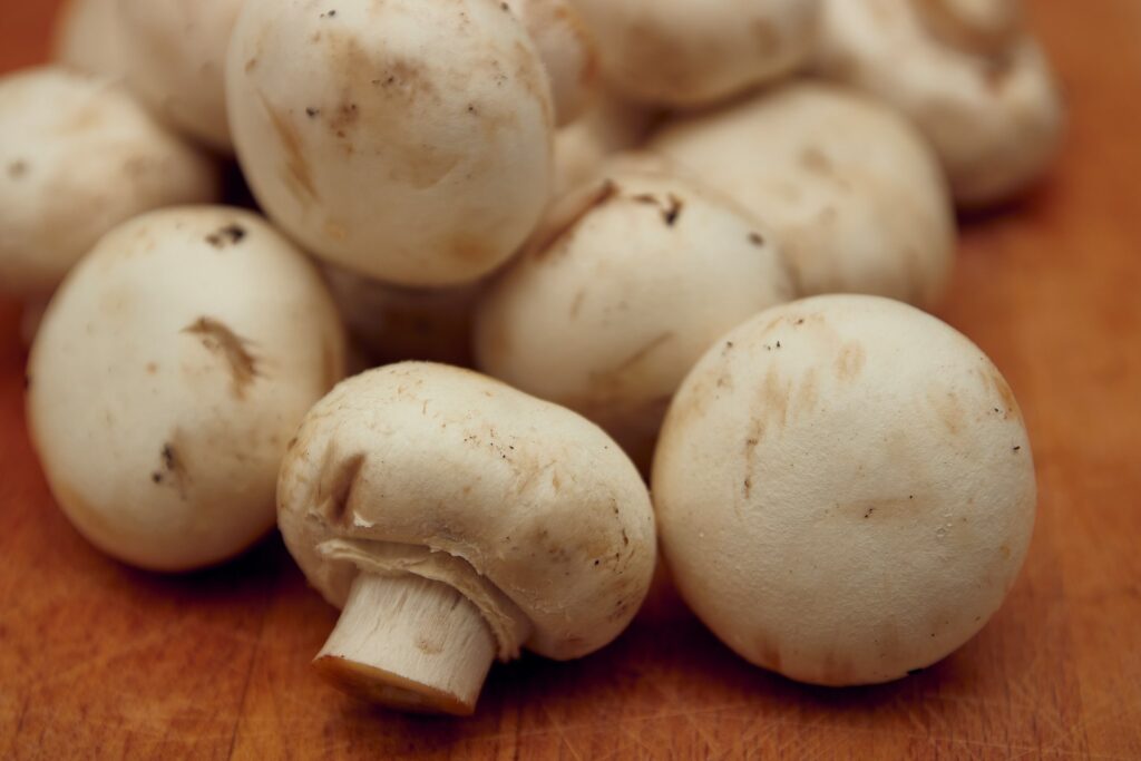 white garlic on brown wooden table
