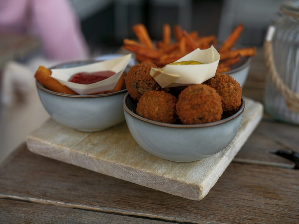 Appetizers: fries, croquettes, and sauce.
