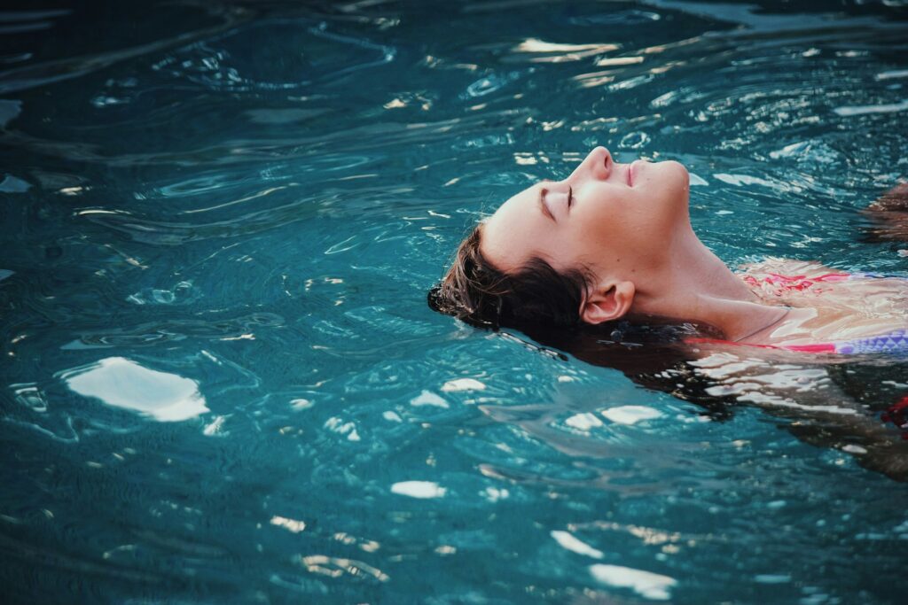 woman floating on body of water
