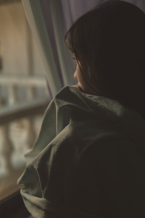 A Sad Girl Looking at the Window