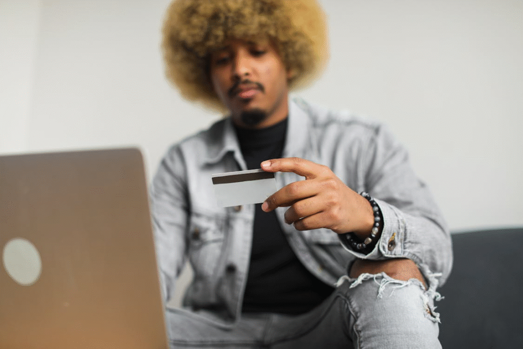 A Man with an Afro Hair Holding a Credit Card

