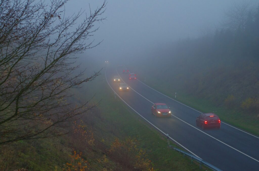 cars on a road with fog
