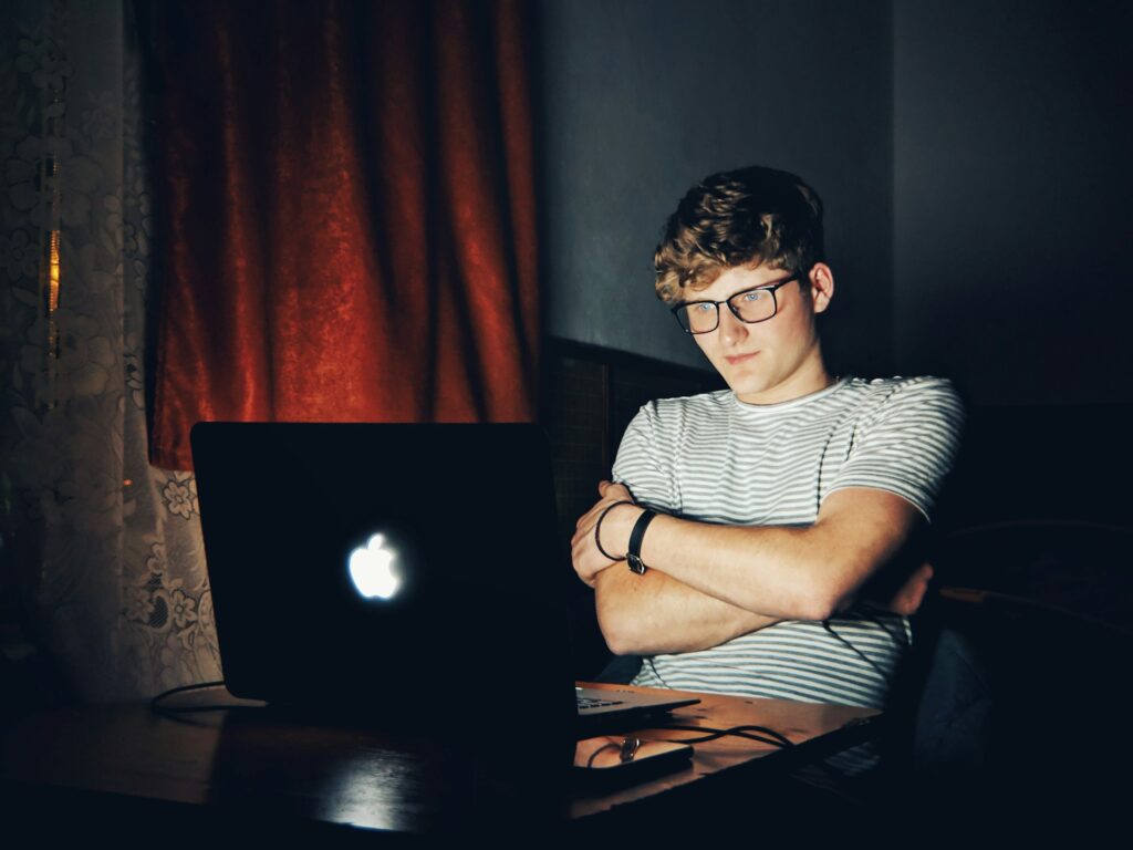 man looking at turned on MacBook
